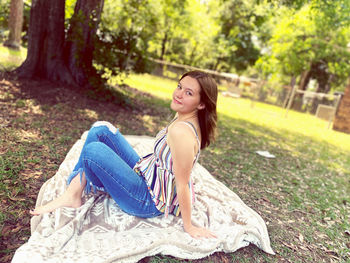 Young woman sitting on field