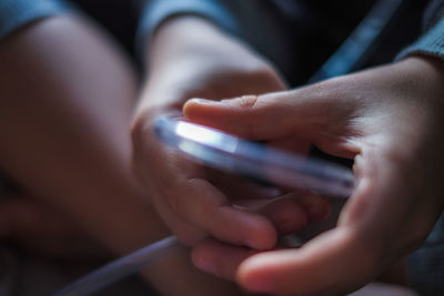 Close-up of hand holding mobile phone