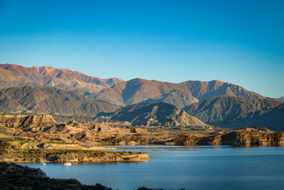 Scenic view of mountains against clear blue sky