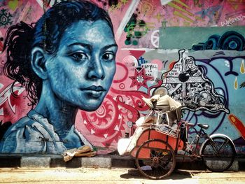 Portrait of man with graffiti on wall