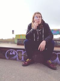 Young woman sitting outdoors