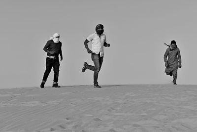 Full length of man walking against clear sky