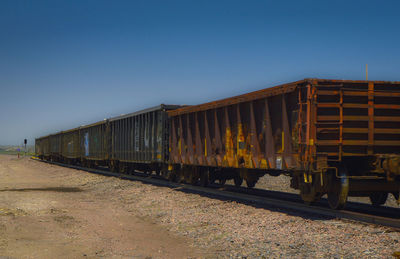 Train on railroad track against clear sky