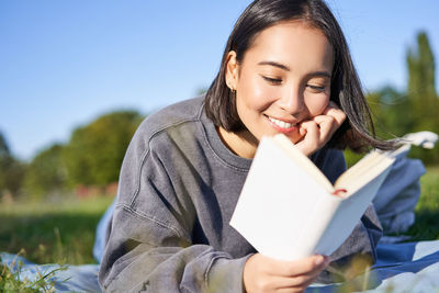 Portrait of young woman using mobile phone