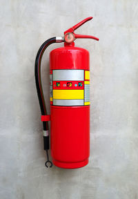 Close-up of red fire extinguisher on wall