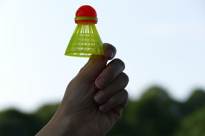 Close-up of hand holding ice cream against clear sky