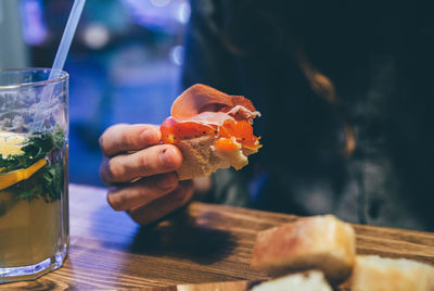 Cropped image of person eating meal