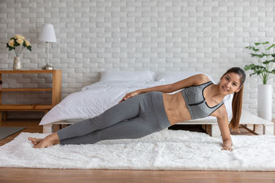 Portrait of woman exercising on floor