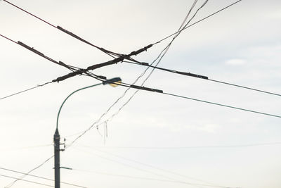 Low angle view of electricity pylon against sky