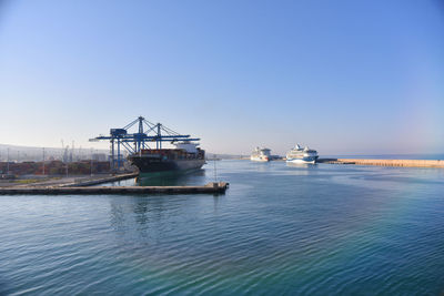 Ship in sea against clear blue sky