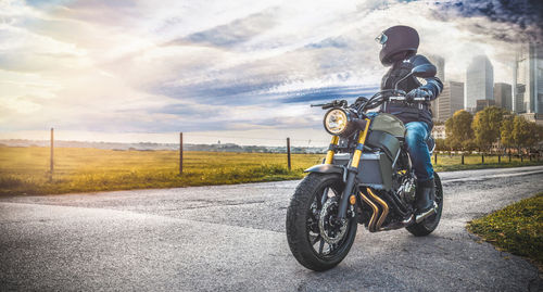 Man riding motorcycle on road