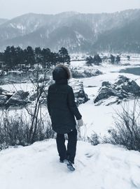 Full length of man standing on snow covered land