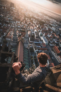 Midsection of man holding modern building in city