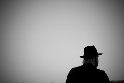 Rear view of silhouette woman standing against clear sky