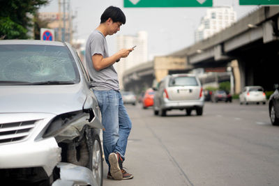 Man standing on street in city