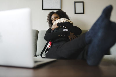 Woman with baby looking at laptop