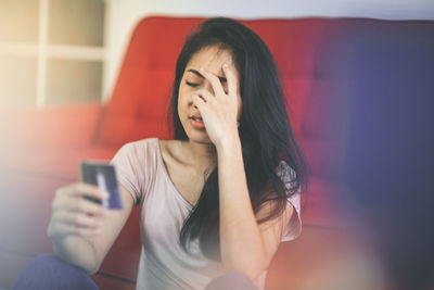 Midsection of woman using mobile phone