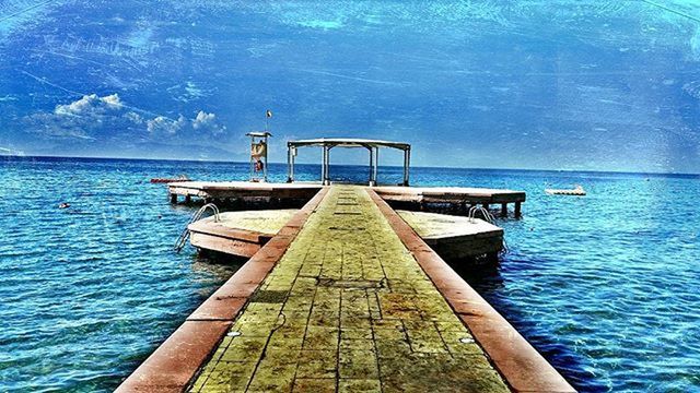 water, sea, pier, blue, horizon over water, sky, tranquility, tranquil scene, the way forward, rippled, jetty, scenics, nature, beauty in nature, transportation, idyllic, wood - material, day, railing, cloud - sky