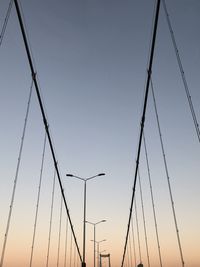 Low angle view of suspension bridge against clear sky