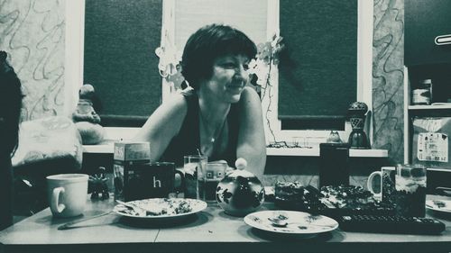 Portrait of woman sitting at restaurant table