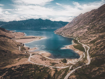 Scenic view of lake and mountains against sky