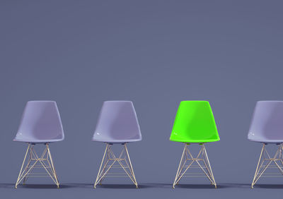 Multi colored chairs against blue background