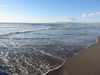 Waves of the sea on the sand beach in winter . forte dei marmi, province of lucca, italy