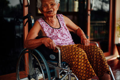 Full length of woman sitting outdoors