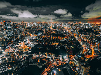 High angle view of illuminated city against sky at night