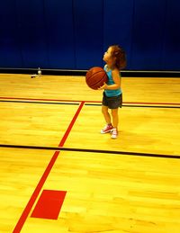 Full length of boy standing on yellow flower