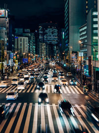 Cars on city street at night