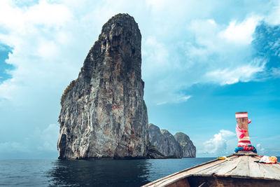 Scenic view of rock formation in sea against sky