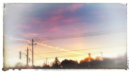 Low angle view of power lines against sky