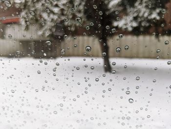 Full frame shot of wet glass window during rainy season