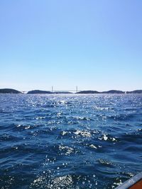Scenic view of sea against clear blue sky