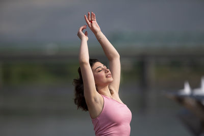 Low section of woman exercising against sky