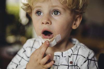 Close-up portrait of boy eating