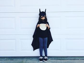 Portrait of a girl wearing batman mask