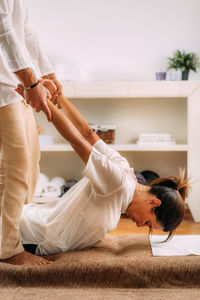 Therapist stretching womans back. shiatsu massage.