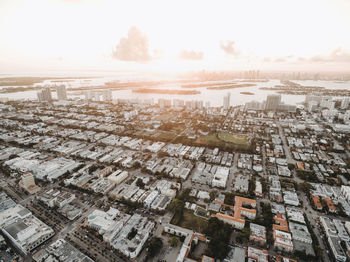 Aerial view of cityscape against sky during sunset