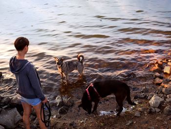 People with dog in water