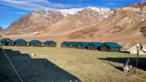 Tent on beach against mountain range