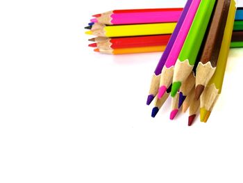 Close-up of colored pencils against white background