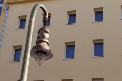 Low angle view of street light against building