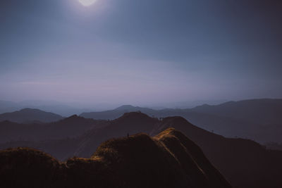 Scenic view of silhouette mountains against sky during sunset