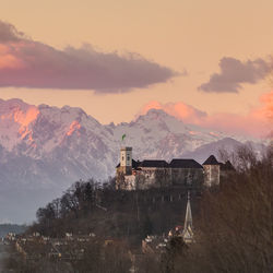 Scenic view of snowcapped mountains against sky during sunset