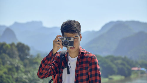 Portrait of teenage girl photographing