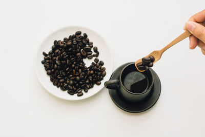 High angle view of hand holding coffee cup