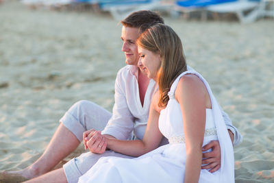 Friends sitting on shore