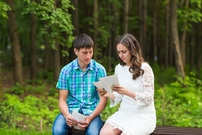 Young couple sitting on mobile phone